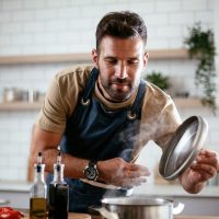 Happy Man Cooking in Kitchen Happy Man Cooking in Kitchen